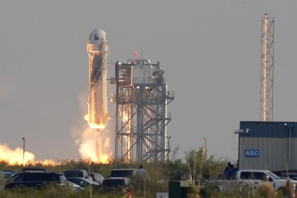 Blue Origin's New Shepard rocket launches carrying passengers Jeff Bezos, founder of Amazon and space tourism company Blue Origin, brother Mark Bezos, Oliver Daemen and Wally Funk, from its spaceport near Van Horn, Texas, Tuesday, July 20, 2021. (AP Photo/Tony Gutierrez)